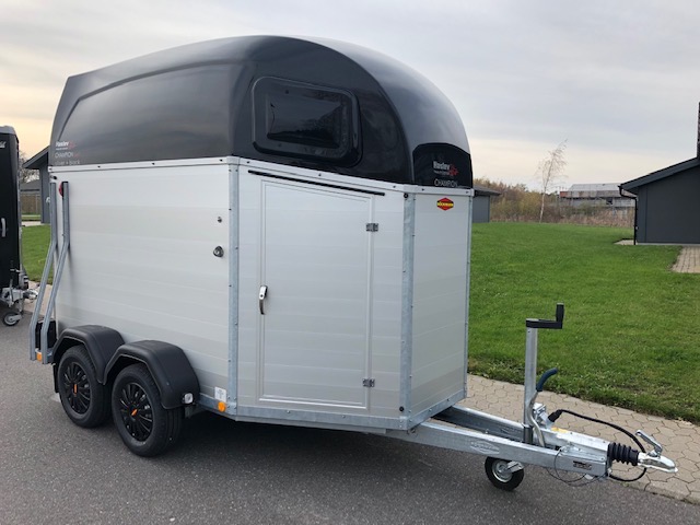 Eight shirts arranged on table in black, olive, grey, blue, white, red, mustard, and green.