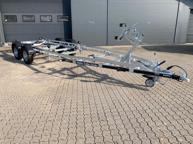 Eight shirts arranged on table in black, olive, grey, blue, white, red, mustard, and green.