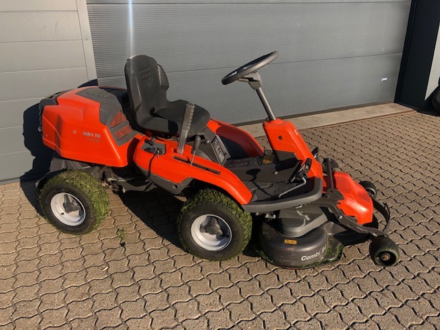 Eight shirts arranged on table in black, olive, grey, blue, white, red, mustard, and green.