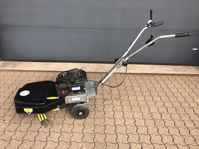 Eight shirts arranged on table in black, olive, grey, blue, white, red, mustard, and green.