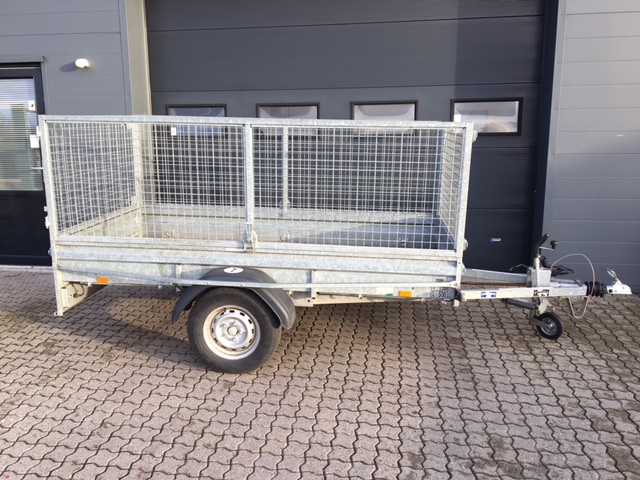 Eight shirts arranged on table in black, olive, grey, blue, white, red, mustard, and green.