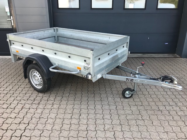 Eight shirts arranged on table in black, olive, grey, blue, white, red, mustard, and green.