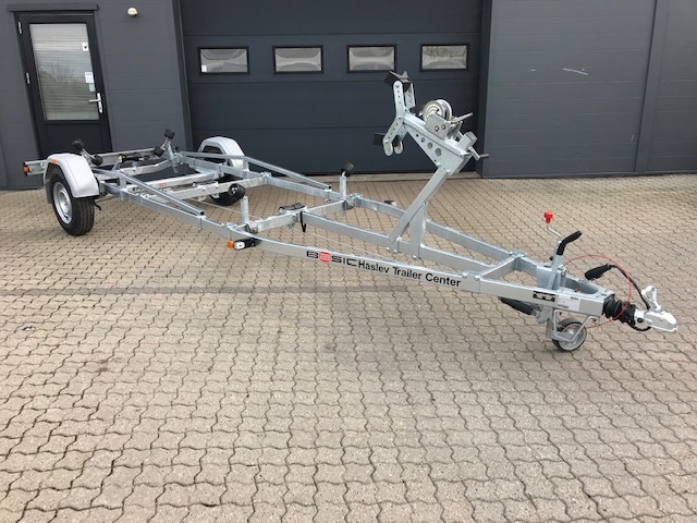 Eight shirts arranged on table in black, olive, grey, blue, white, red, mustard, and green.
