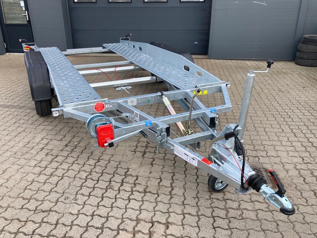 Eight shirts arranged on table in black, olive, grey, blue, white, red, mustard, and green.