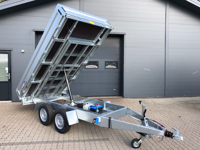 Eight shirts arranged on table in black, olive, grey, blue, white, red, mustard, and green.