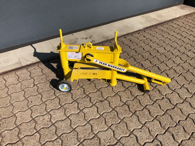 Eight shirts arranged on table in black, olive, grey, blue, white, red, mustard, and green.