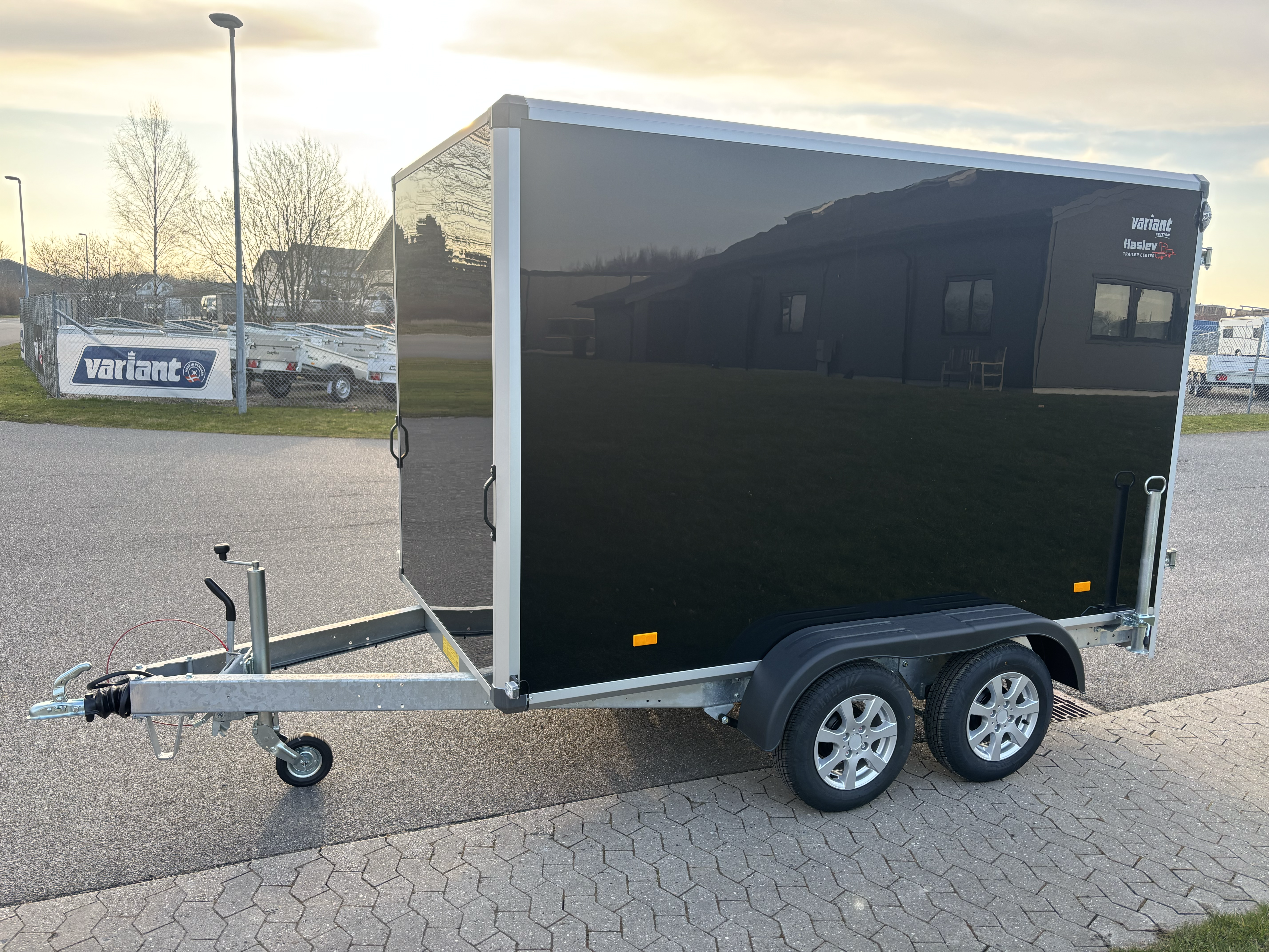 Eight shirts arranged on table in black, olive, grey, blue, white, red, mustard, and green.