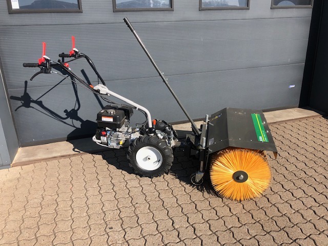 Eight shirts arranged on table in black, olive, grey, blue, white, red, mustard, and green.